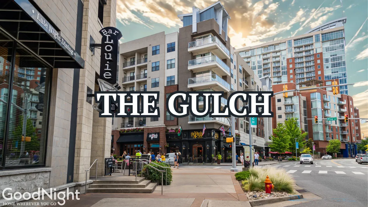 This image shows the exterior of Bar Louie, a lively spot in a modern neighborhood setting, with active street life and visible modern apartments in the background. People are seen dining and socializing, evoking the vibrant atmosphere of Nashville's urban dining and entertainment districts.